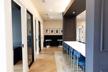 A long hallway with a table and chairs at the end.